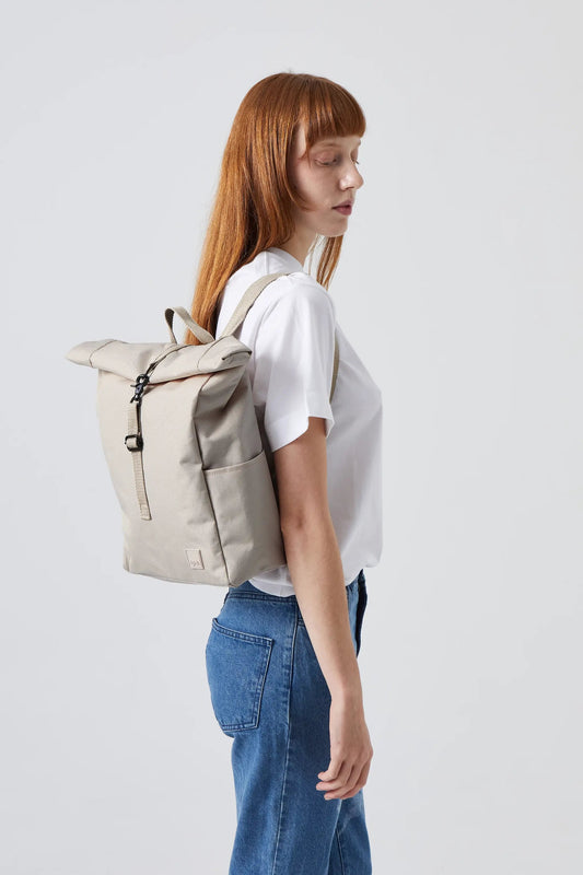Roll Mini Backpack Ash by Lefrik USA with padded laptop sleeve, beige roll-top backpack on model on Tampa Home & Garden Store