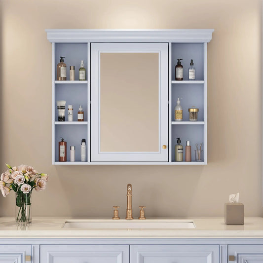 Blue wall mounted bathroom cabinet with mirror and side shelves filled with bottles, crown molding on Tampa Home & Garden Store