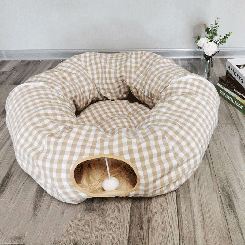 Cat tunnel sleeping nest in beige checkered fabric with circular entrance and hanging pom-pom toy on Tampa Home & Garden Store