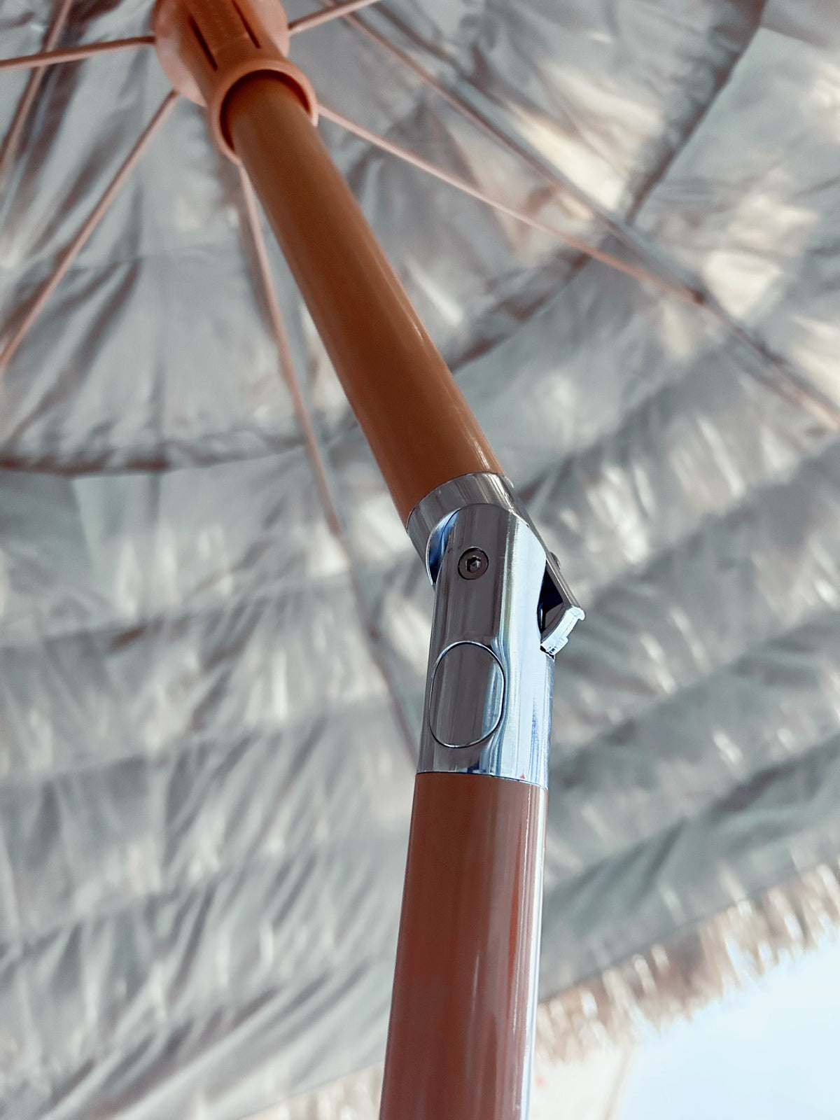 8' Thatched Patio Tiki Umbrella pole with brown shaft and chrome clamp under thatch canopy on Tampa Home & Garden Store