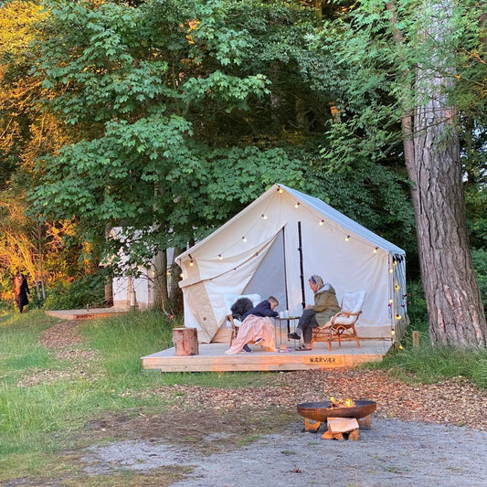Alpha Wall Tent 10x12 by White Duck Outdoors cream canvas four-season with string lights on Tampa Home & Garden Store