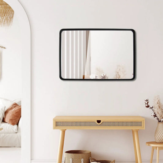 Rectangular wall-mount vanity mirror with a black metal frame above a light wood console on Tampa Home & Garden Store