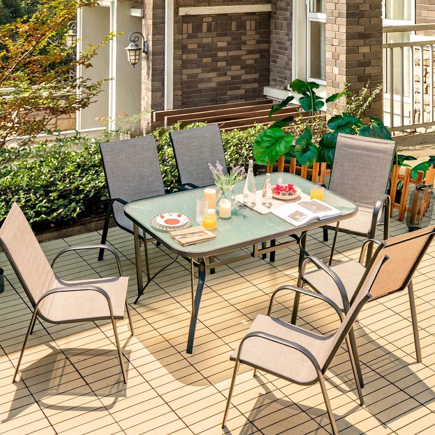 7-Piece patio dining set with glass-top table and six stackable chairs on deck on Tampa Home & Garden Store