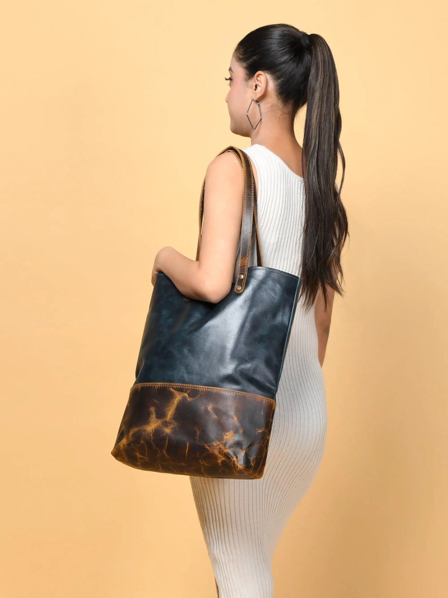 Green women's leather tote bag with brown distressed bottom panel and tan straps on Tampa Home & Garden Store