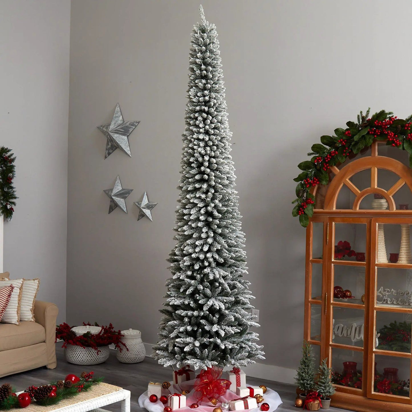 11 ft flocked pencil Christmas tree with 850 lights in a cozy living room on Tampa Home & Garden Store