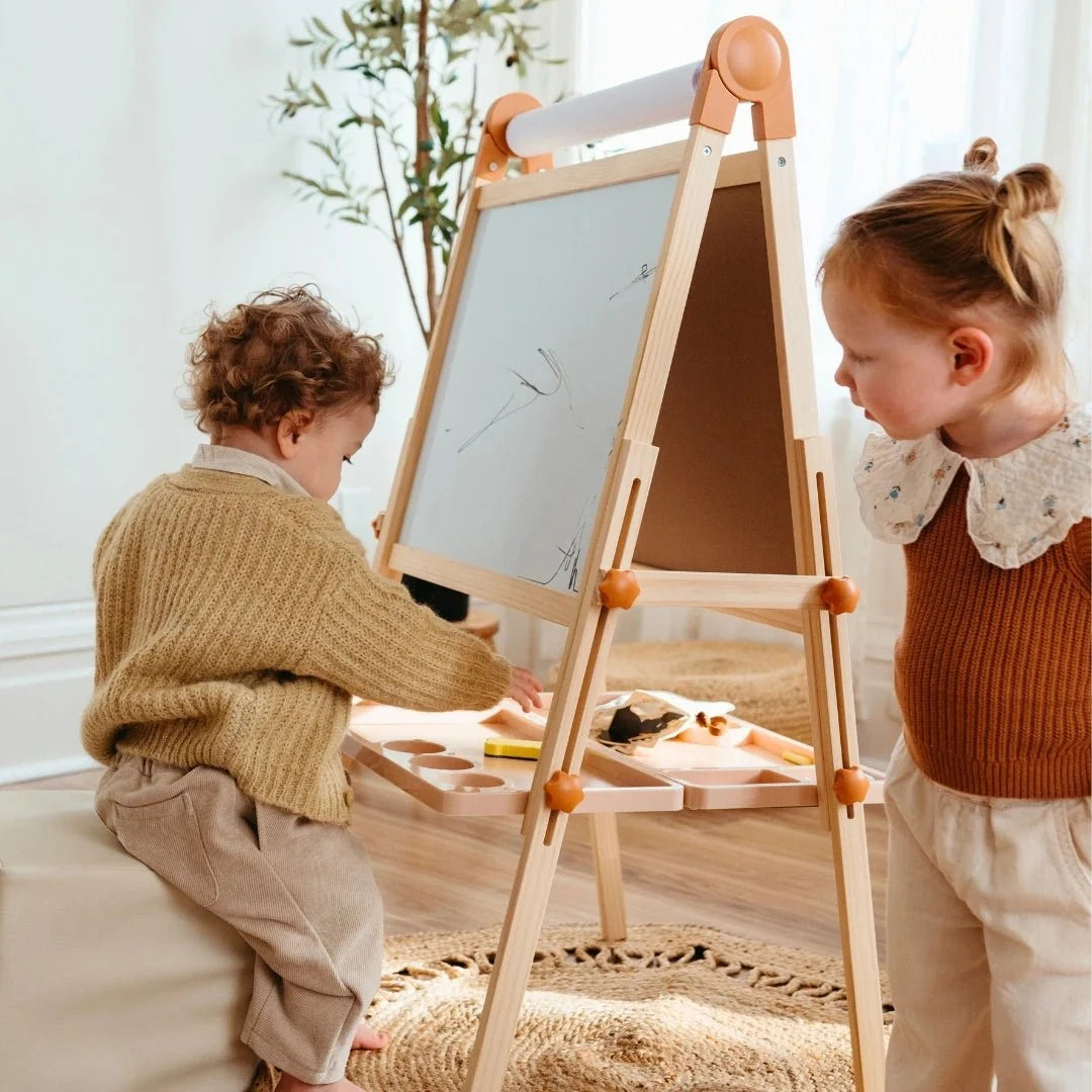 Tiny Land Magnitales Kids Easel in caramel wood with orange joints and paper roll on board on Tampa Home & Garden Store