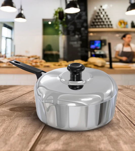 Magnaware 12 Inch aluminum saute pan with lid, black knob and handle on a wooden counter on Tampa Home & Garden Store
