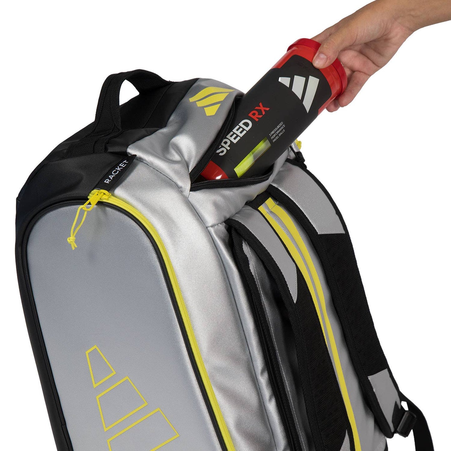 Adidas Padel Tour Silver racket bag with yellow zippers; hand inserts red Speed RX bottle on Tampa Home & Garden Store