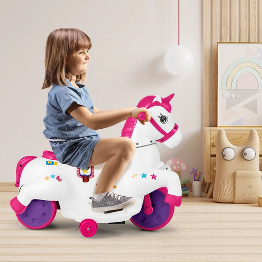 12V unicorn ride-on toy in white with pink mane, horn and purple wheels as a child rides on Tampa Home & Garden Store