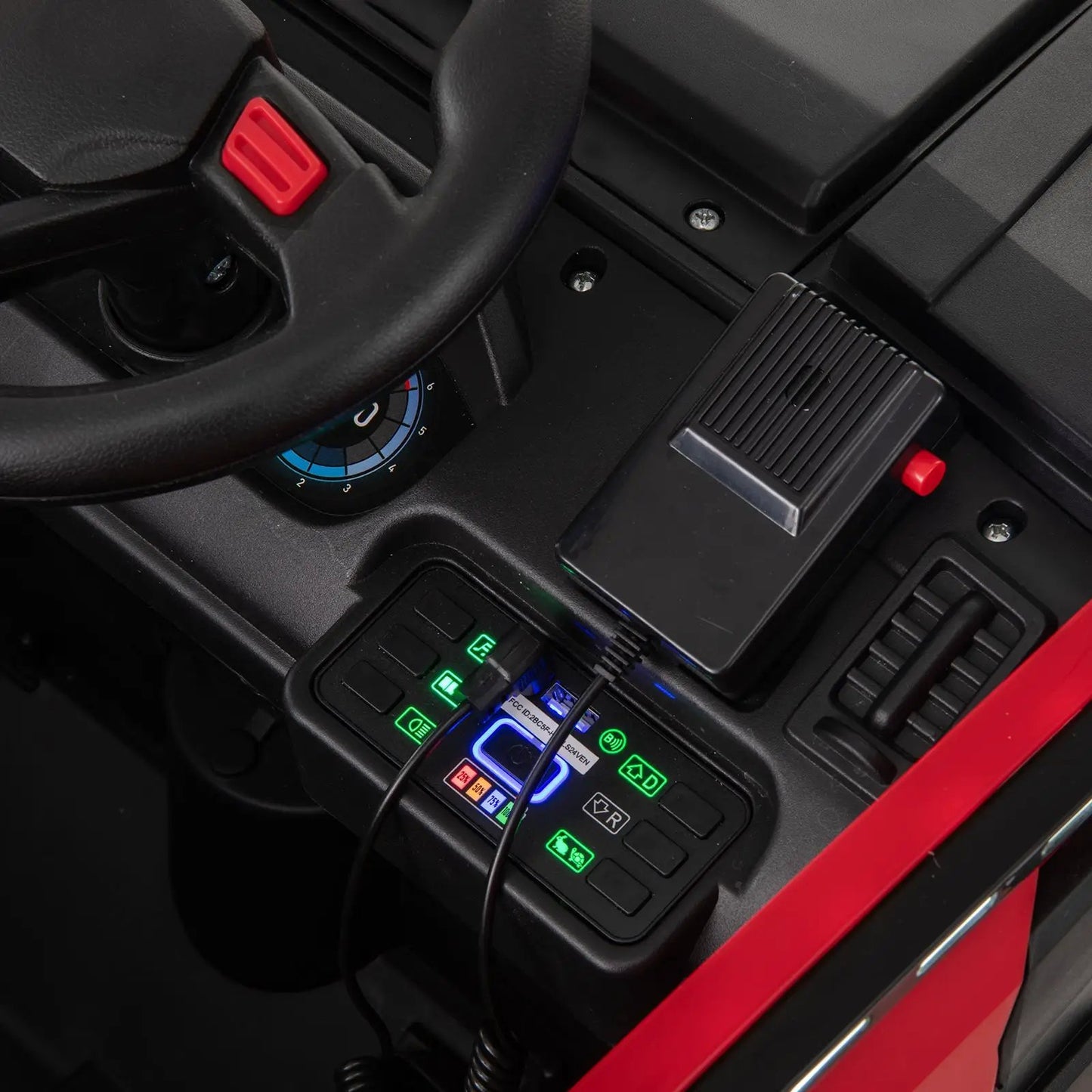 12V kids ride-on fire truck interior with steering wheel and illuminated dashboard in red on Tampa Home & Garden Store
