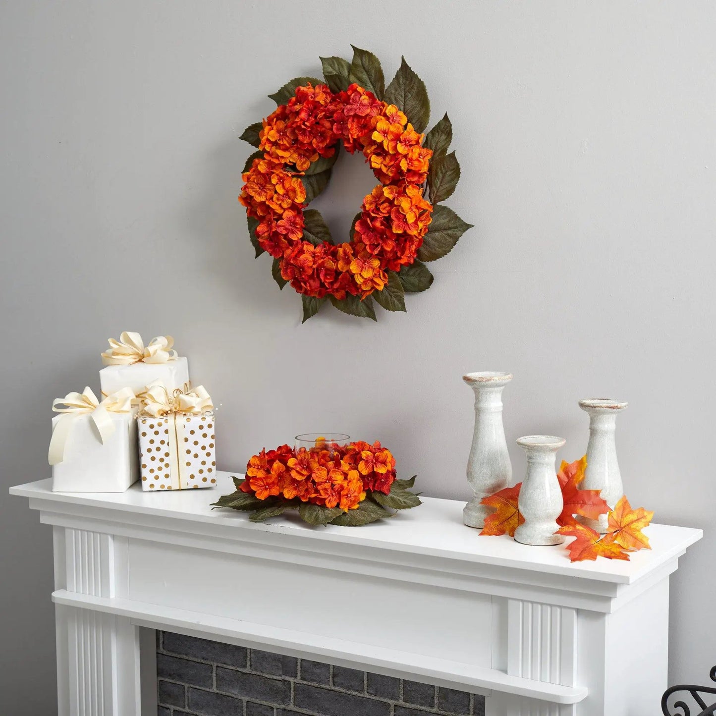 Artificial autumn hydrangea candelabrum with orange-red blooms and green leaves on mantel on Tampa Home & Garden Store