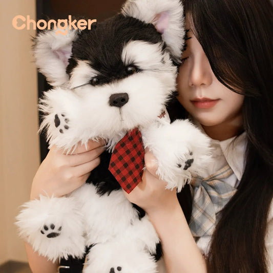 Black and White Schnauzer Backpack plush with red plaid tie Chongker brand held by a woman on Tampa Home & Garden Store
