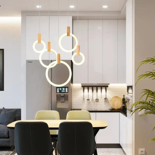 Round wooden ring LED pendant lamp set with circular rings hanging over a dining area on Tampa Home & Garden Store