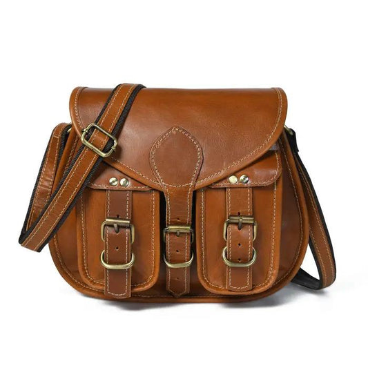 Tan leather sling crossbody bag for women with two pockets and brass buckles, adjustable strap on Tampa Home & Garden Store