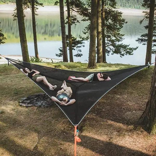 Triangular aerial hammock tent mesh bed between trees with three people relaxing on Tampa Home & Garden Store