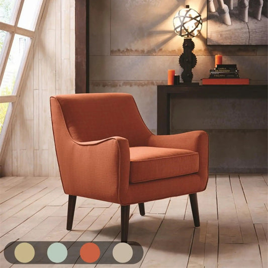 Accent chair upholstered in burnt orange fabric with black tapered legs in a modern living room on Tampa Home & Garden Store