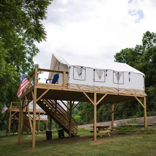 Alpha 16x20 Wall Tent with Poles and Floor by White Duck Outdoors on elevated wooden deck on Tampa Home & Garden Store