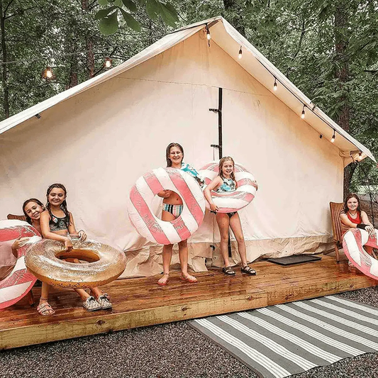 White Duck Outdoors Alpha Wall Tent 16x24 on deck with string lights and kids with donuts on Tampa Home & Garden Store