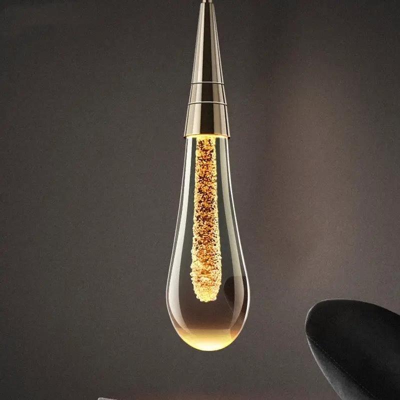 Postmodern crystal teardrop pendant light by Decorbites with warm amber glow on Tampa Home & Garden Store