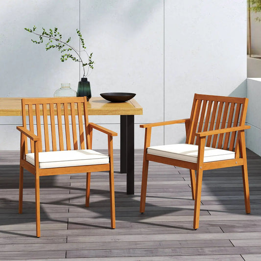 2-piece acacia wood patio dining chairs with white cushions on a wooden deck on Tampa Home & Garden Store