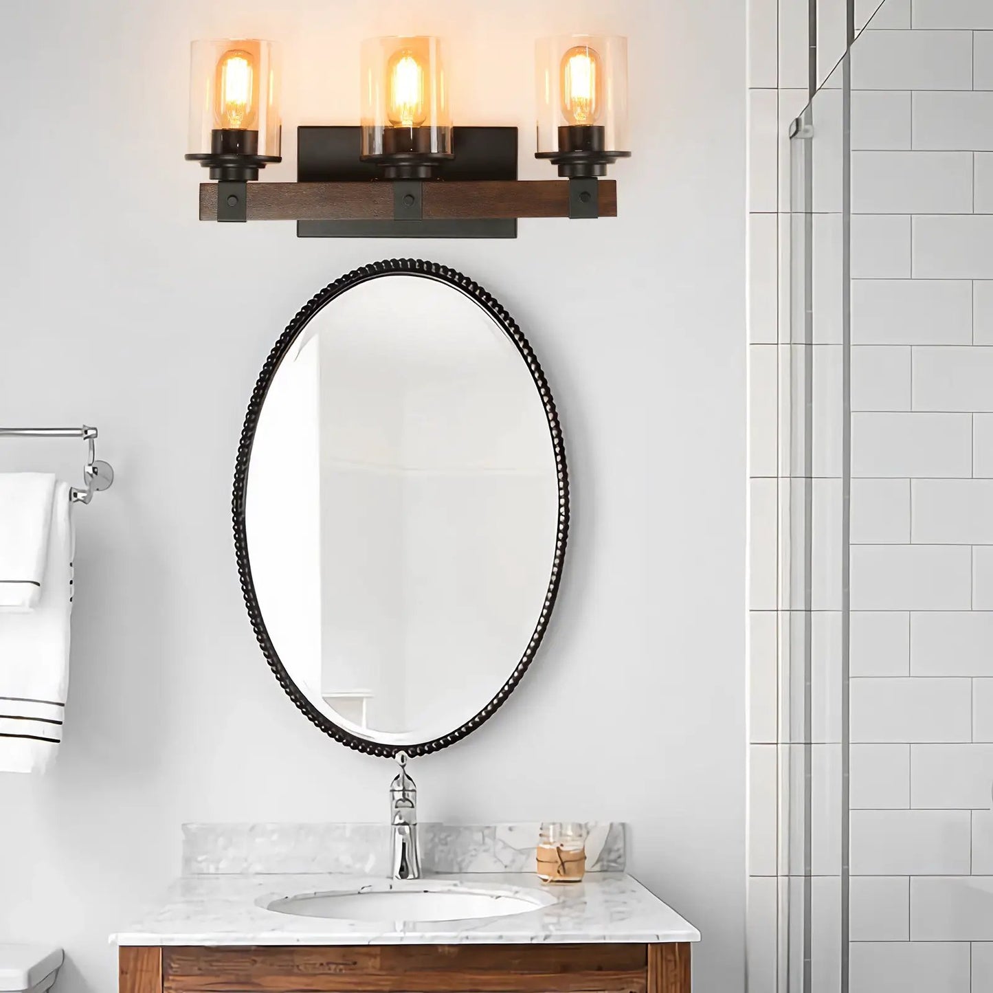 Walnut farmhouse vanity three-light wall fixture with clear glass shades and black metal mounts on Tampa Home & Garden Store