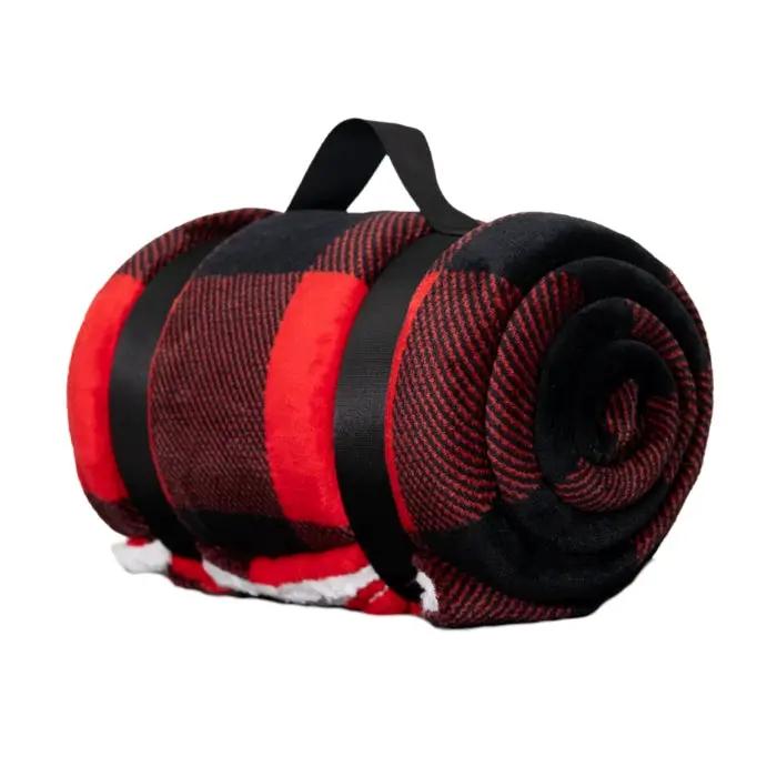Red buffalo plaid sherpa throw blanket rolled with a black carry strap for outdoor living on Tampa Home & Garden Store