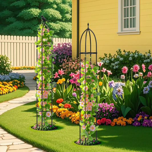 Two-pack black metal garden obelisk trellises for climbing plants in a vibrant flower bed on Tampa Home & Garden Store