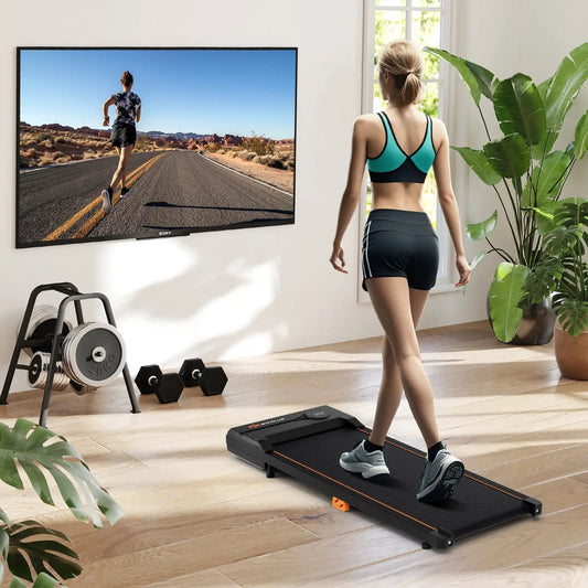 Under Desk Treadmill with Remote for Home Office DirectDeals, black with orange trim in a room on Tampa Home & Garden Store