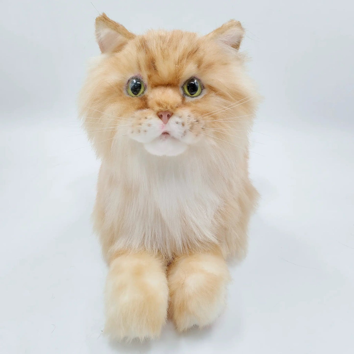 Plush orange cat weighted life-size companion with fluffy fur, large green eyes, pink nose on Tampa Home & Garden Store