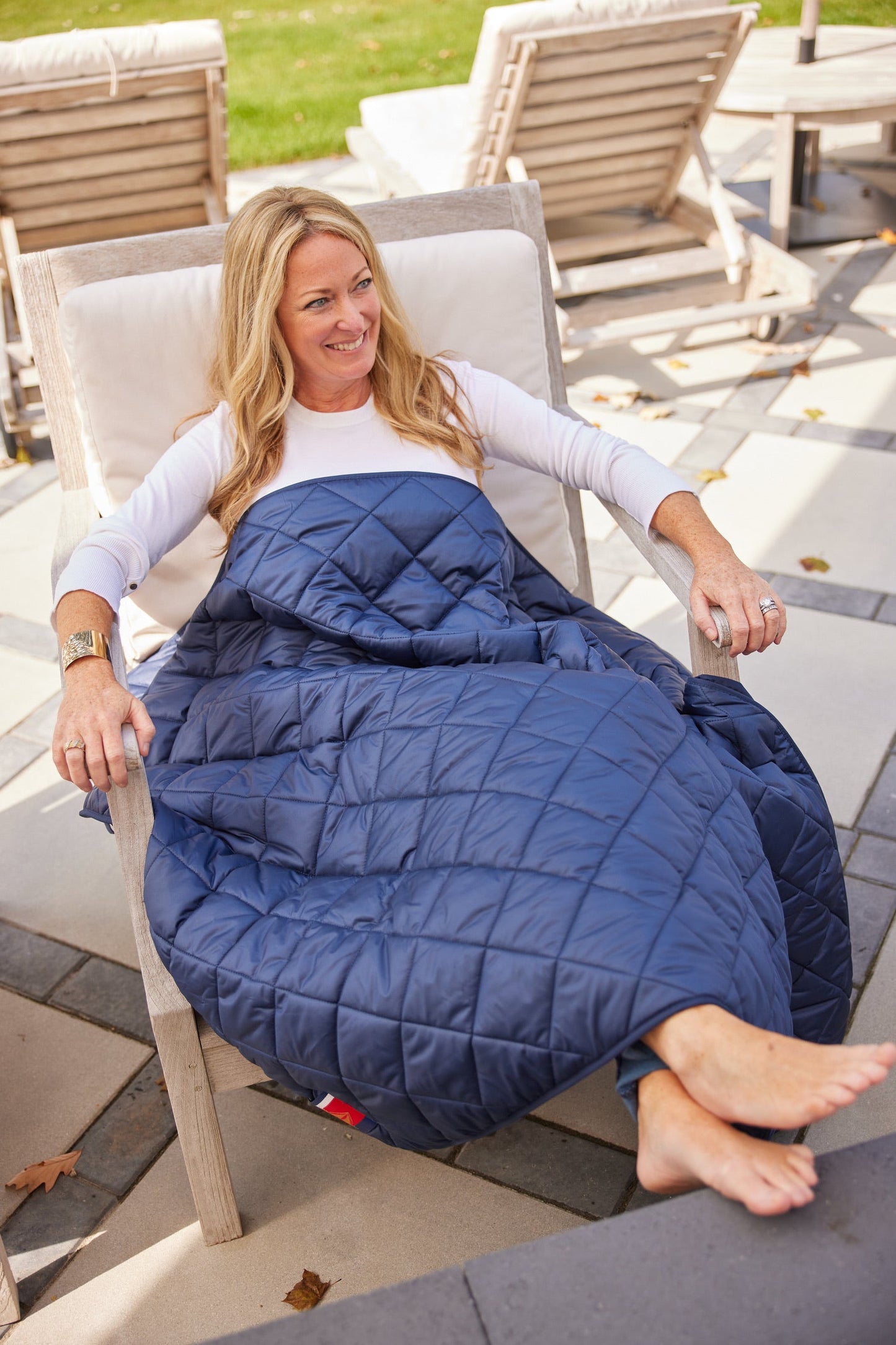 Beach Day Navy Puffer Blanket, quilted outdoor blanket on a lounge chair on Tampa Home & Garden Store