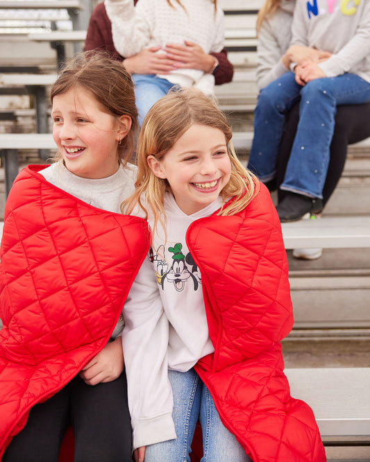 Baseball on Red Puffer Blanket by Pretty Rugged, red quilted blanket worn by kids on bleachers on Tampa Home & Garden Store