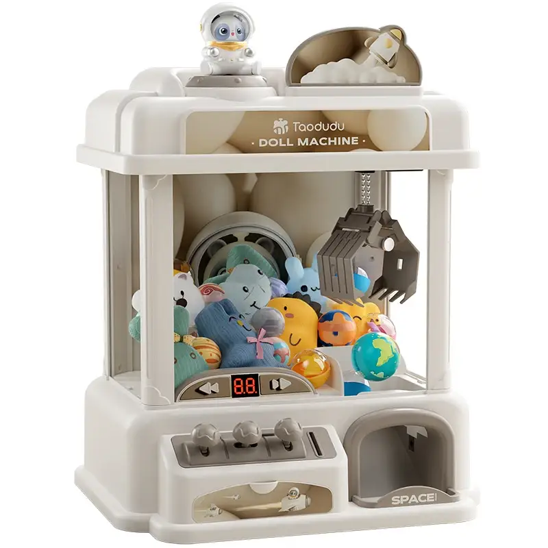 Toy Claw Machine with plush prizes in a white arcade cabinet by Moktan Sabai on Tampa Home & Garden Store