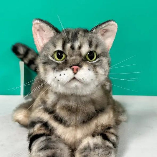 Plush American Shorthair life-size cat by Chongker with gray striped fur and green eyes on Tampa Home & Garden Store