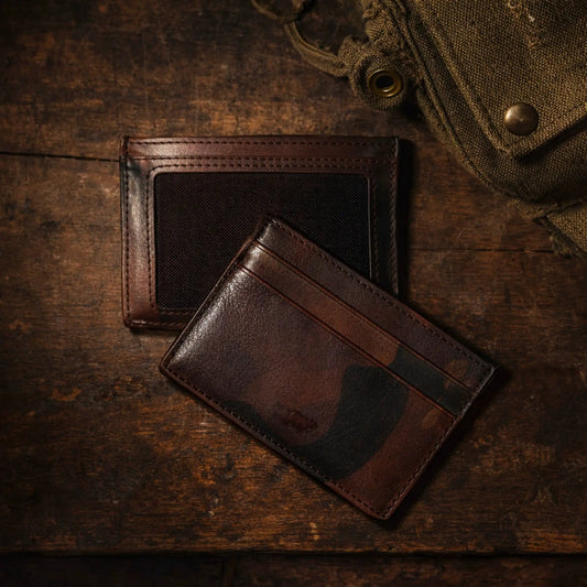 Three camouflage military calfskin card cases with ID by Will Leather Goods on wood surface on Tampa Home & Garden Store