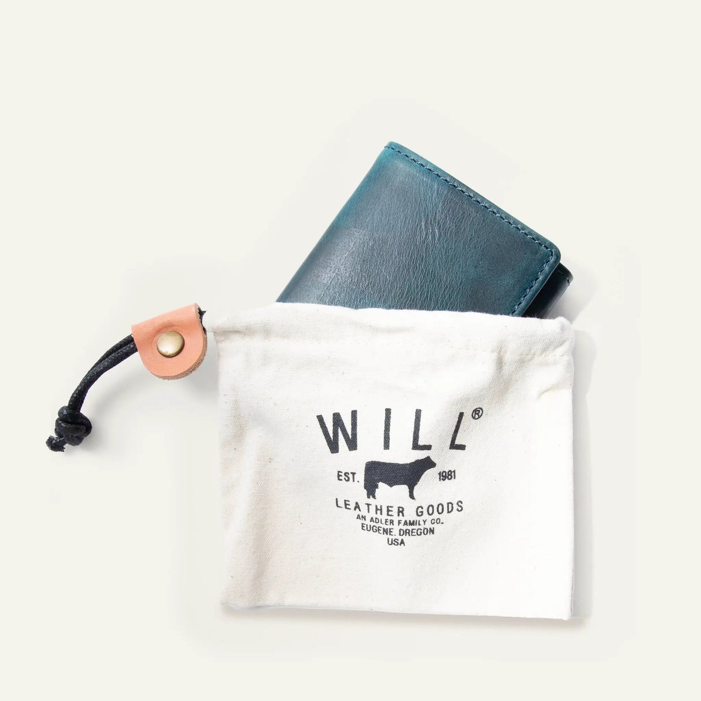 Military Trifold Wallet teal leather with subtle stitching by Will Leather Goods on a cloth bag on Tampa Home & Garden Store