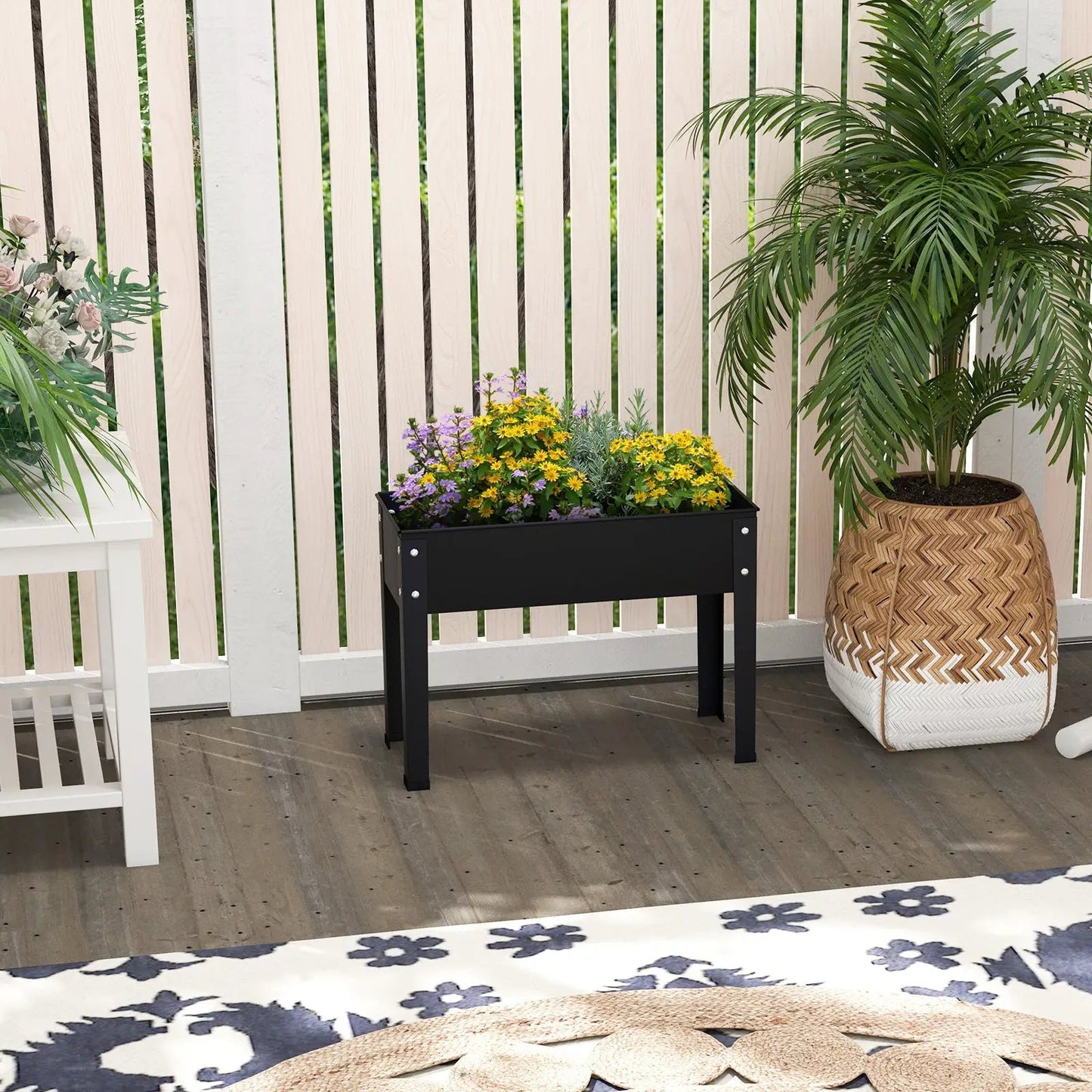 Metal Raised Garden Bed with Legs and Drainage black metal frame filled with yellow flowers on Tampa Home & Garden Store