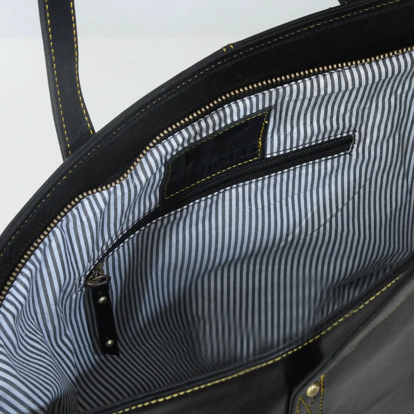 Kim Tote Bag leather handbag in black with yellow topstitching and striped lining on Tampa Home & Garden Store