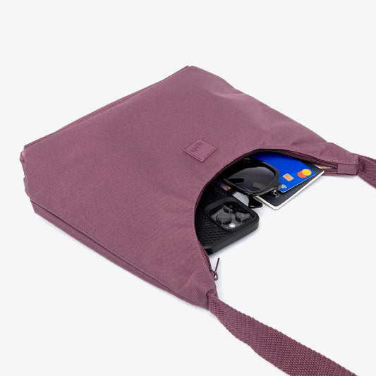 Bico Bag Maroon Crescent crossbody with zipper opening showing phone, sunglasses and cards on Tampa Home & Garden Store