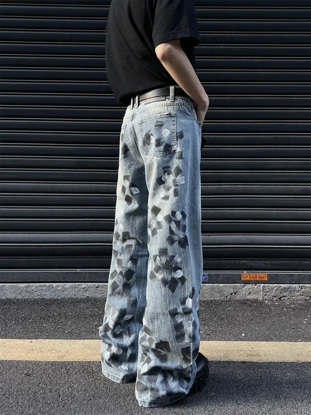 Men's Slightly Flared Wide-Leg Jeans in light blue denim with black paint-splatter pattern on Tampa Home & Garden Store