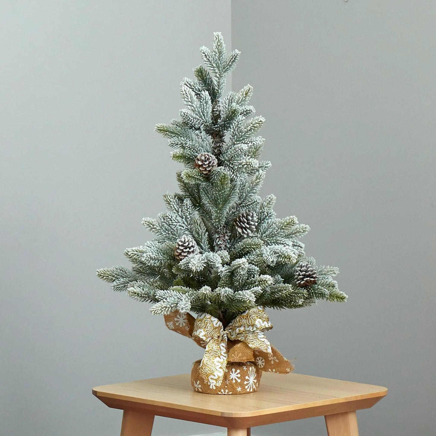 28-inch flocked Christmas tree with pine cones and snow-dusted needles, burlap base on Tampa Home & Garden Store