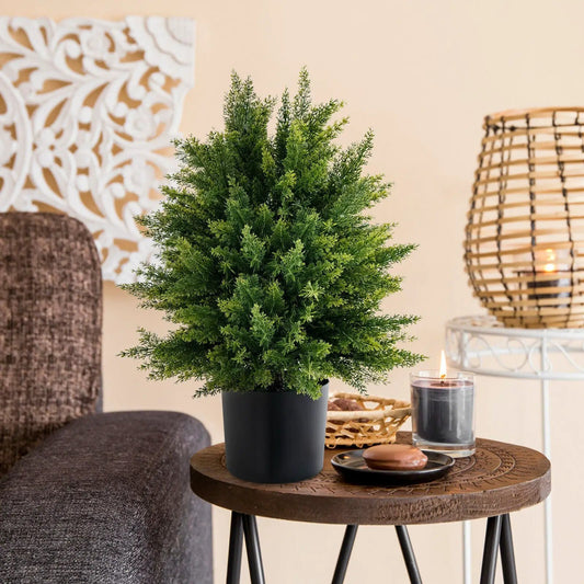 Artificial cedar topiary ball tree in black cement pot on round wooden table on Tampa Home & Garden Store