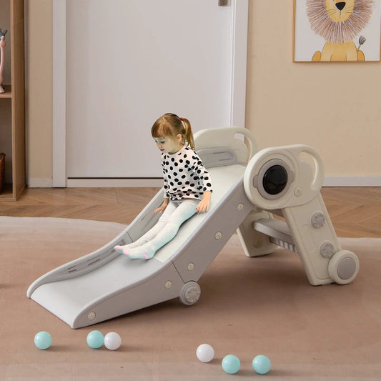 2 in 1 toddler slide with climber in gray plastic, girl in polka-dot shirt sits on slide indoors on Tampa Home & Garden Store