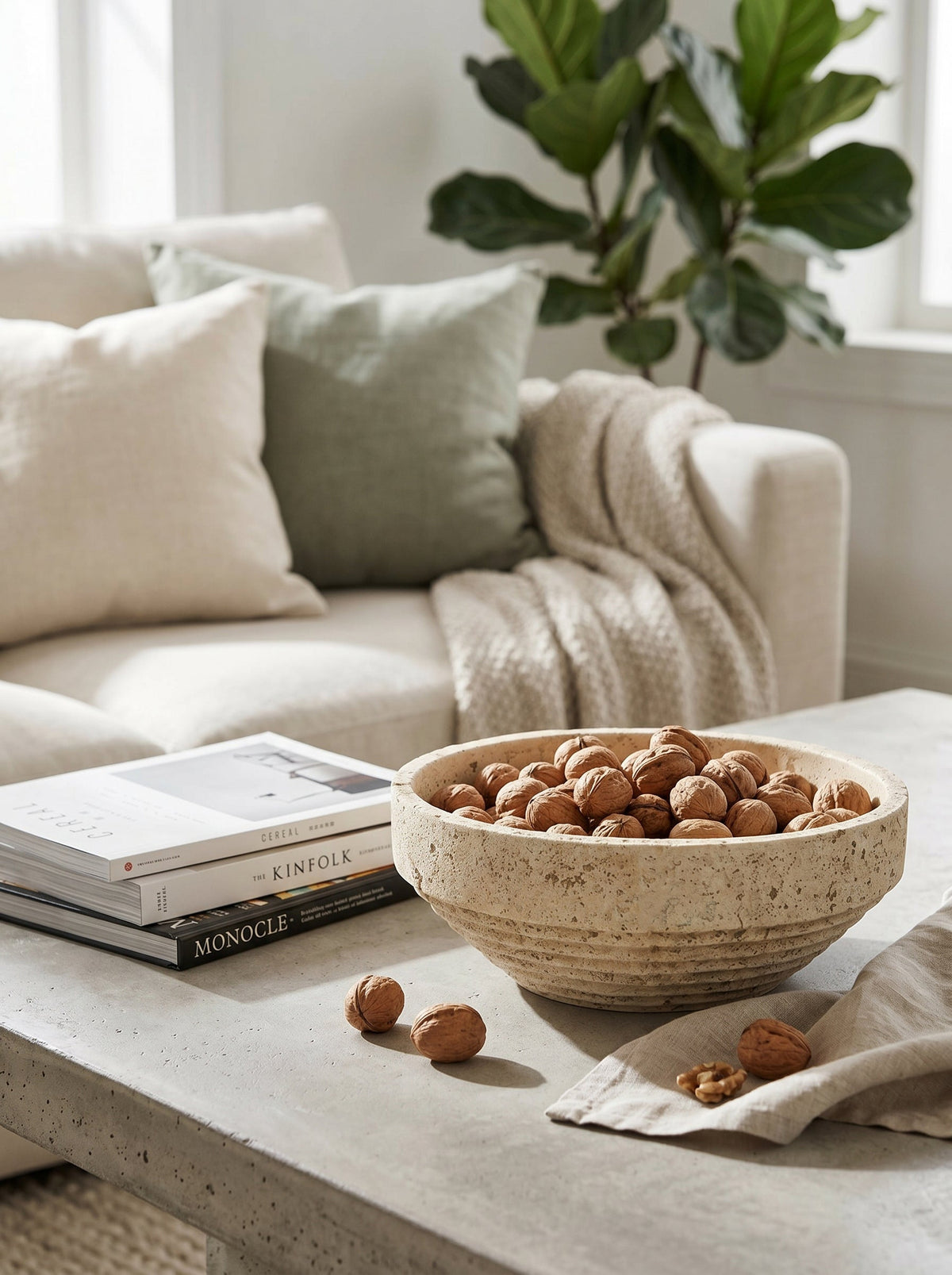 Cement ribbed decorative bowl with tiered base on a light coffee table filled with walnuts on Tampa Home & Garden Store