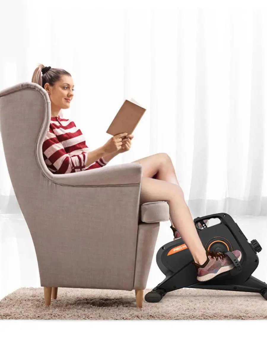 Feilton magnetic elliptical trainer for home gym black with orange beside beige chair on Tampa Home & Garden Store