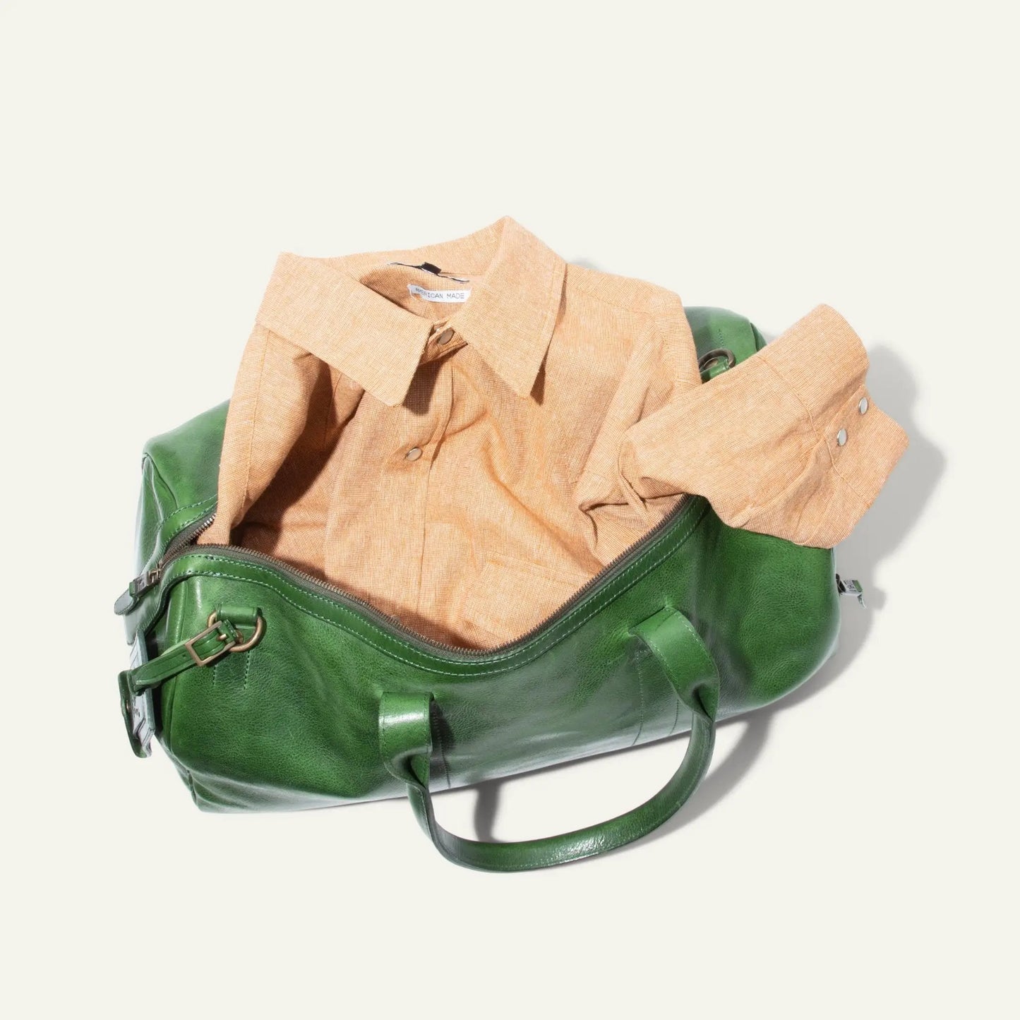Expedition Duffle Bag in Italian Leather by Will Leather Goods green leather bag with tan shirt on Tampa Home & Garden Store