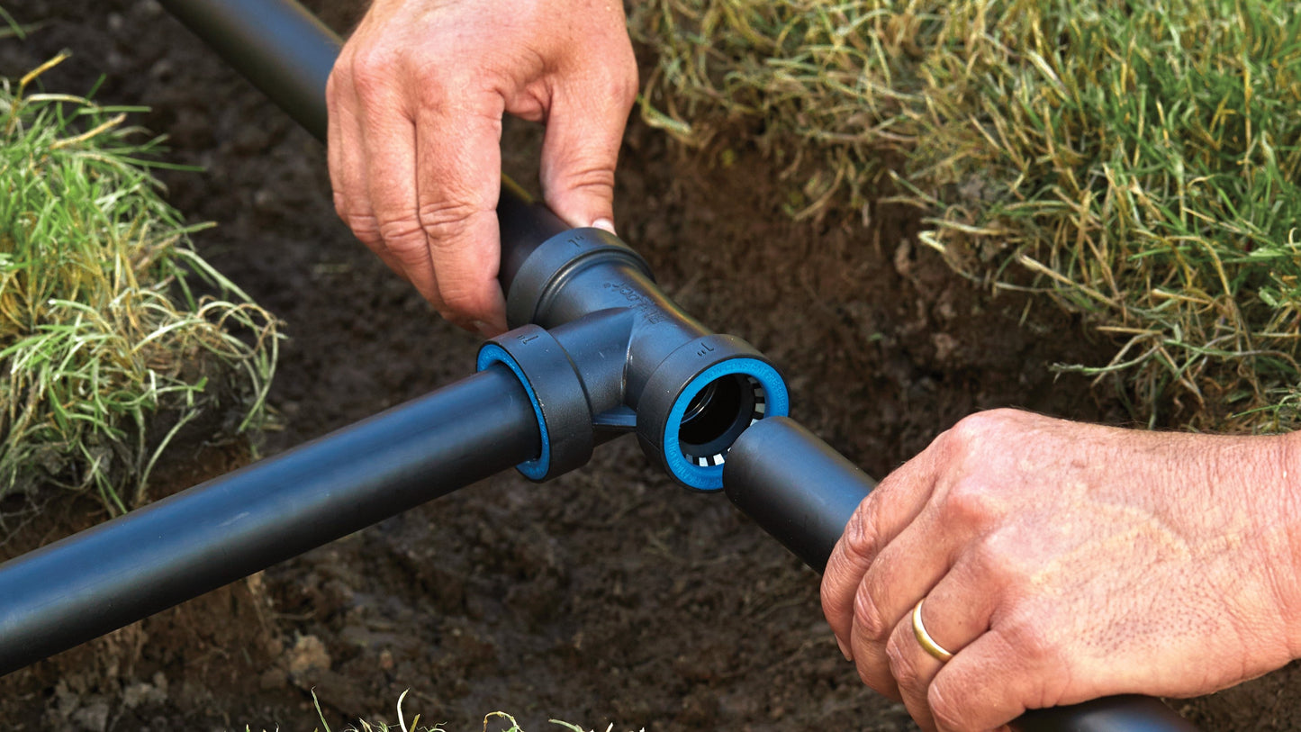 1 in Blu-Lock Tee for poly pipe sprinkler system by Orbit Irrigation; blue-gray connector being installed on Tampa Home & Garden Store