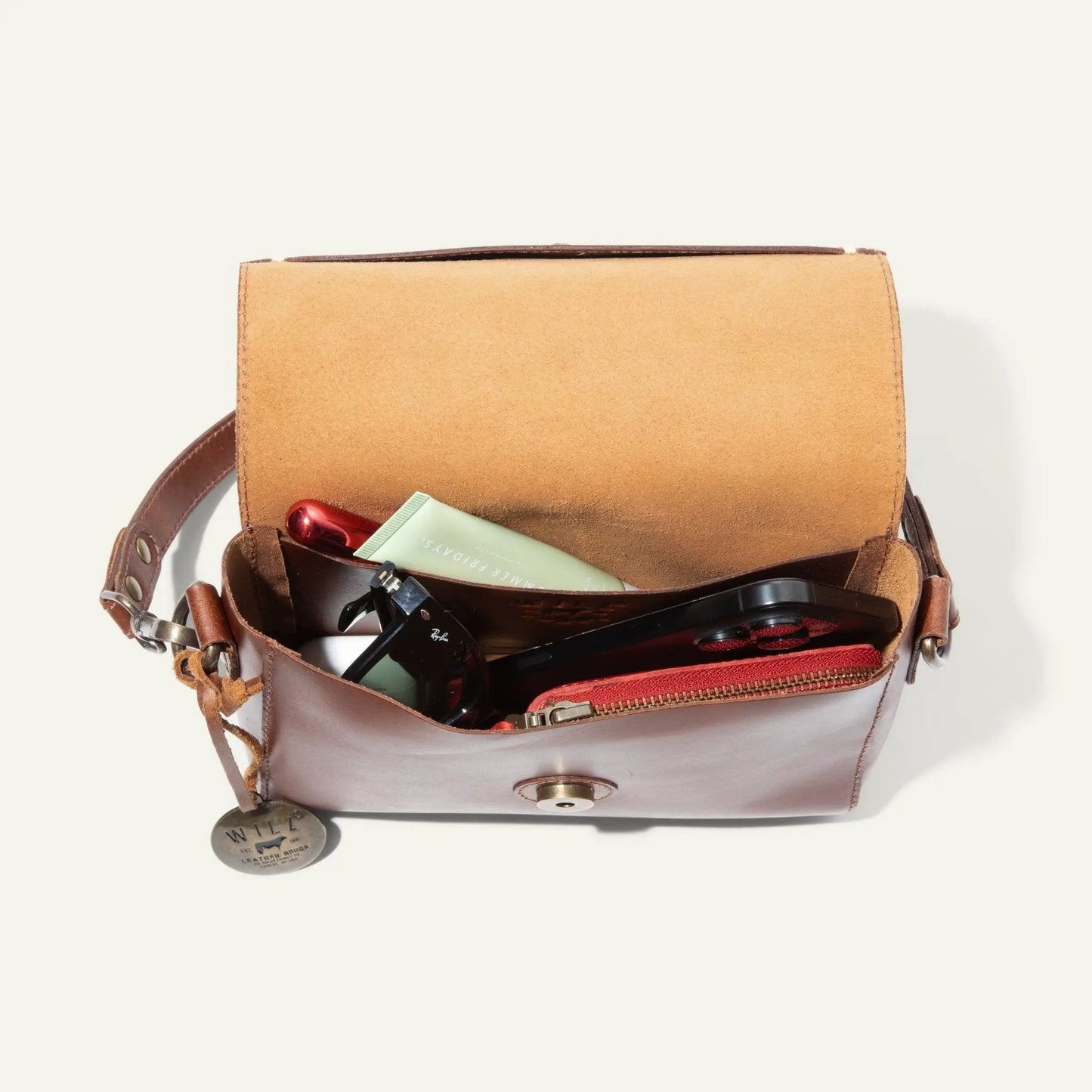 Will Leather Goods Simple Mini Flap Leather Crossbody Bag in tan; interior with sunglasses on Tampa Home & Garden Store