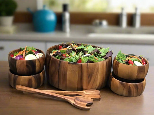 Extra Large Acacia Salad Bowl Set with Servers featuring five bowls on a kitchen counter on Tampa Home & Garden Store