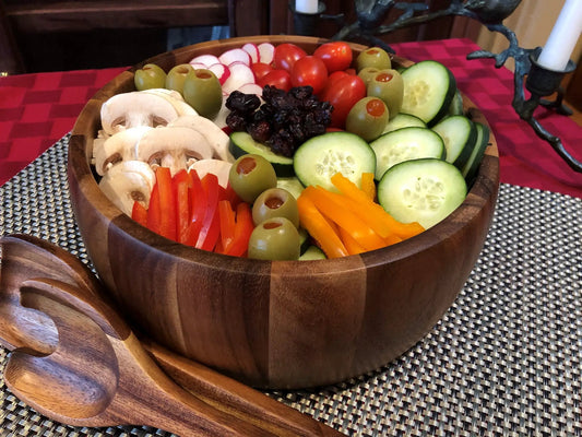 Large acacia wood salad bowl with servers, filled with cucumber slices and olives on Tampa Home & Garden Store