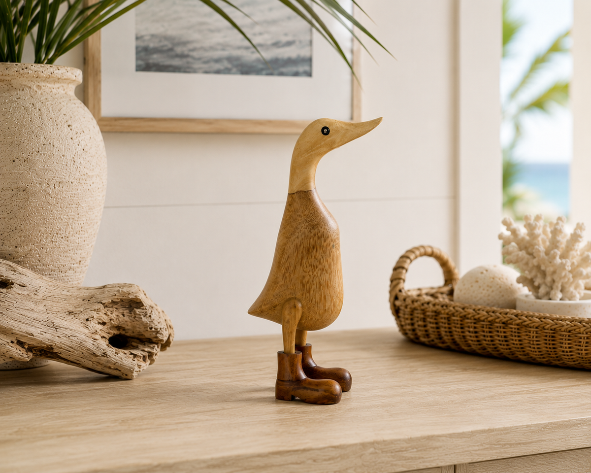 Bali hand-carved bamboo duck sculpture with booted feet on a wooden surface on Tampa Home & Garden Store